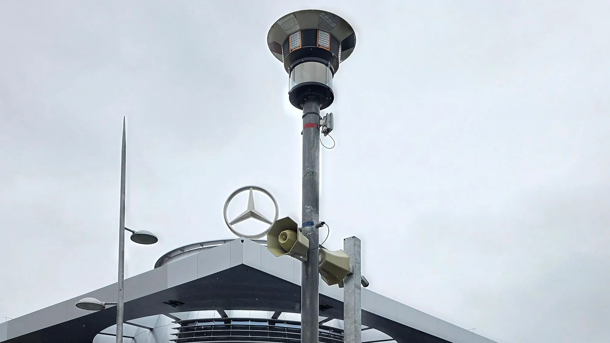 MOVETOS mast with camera head and two loudspeakers in front of the Mercedes-Benz Center in Stuttgart